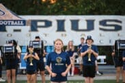 Zoe Leiner, senior drum major, leads the Marching Golden Lions on the field at the St. Pius X football game Sept. 19 to perform the national anthem.